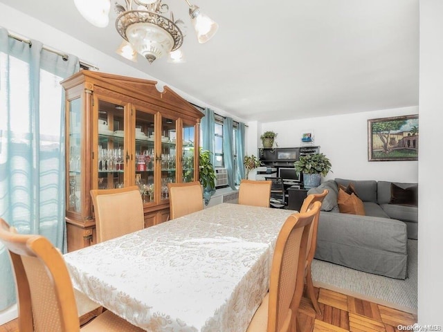 dining room with a chandelier and light parquet floors