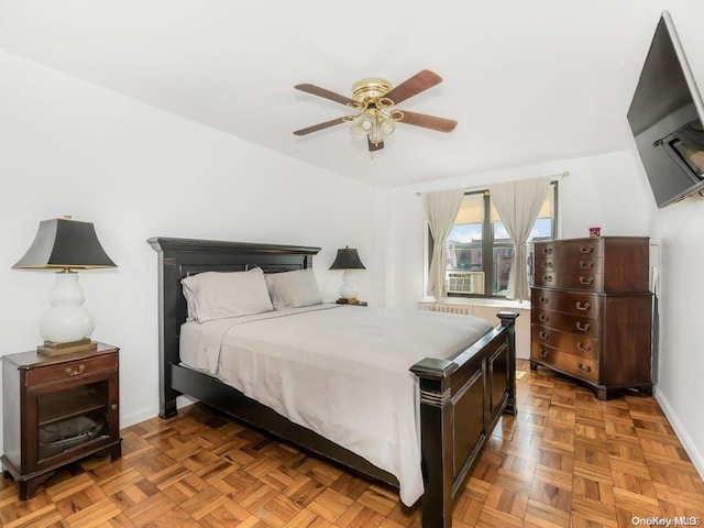 bedroom with light parquet flooring and ceiling fan