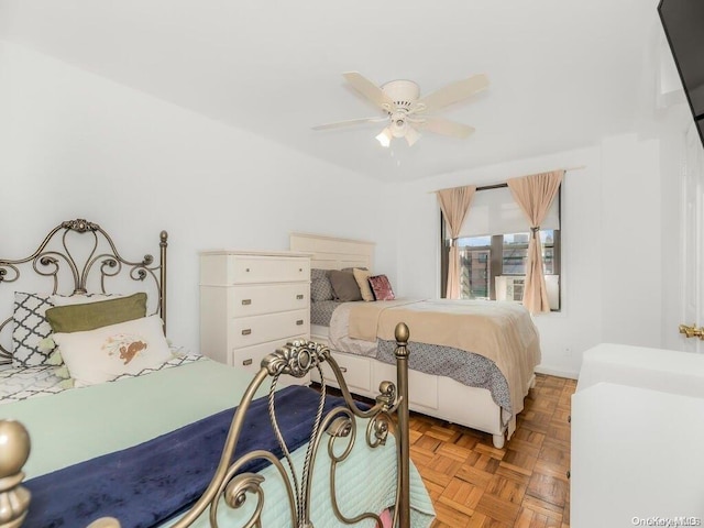 bedroom featuring ceiling fan and light parquet flooring