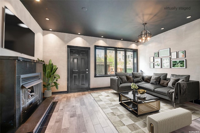 living room with light wood-type flooring and a notable chandelier