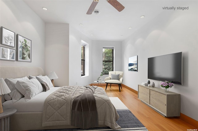 bedroom featuring ceiling fan and light hardwood / wood-style floors