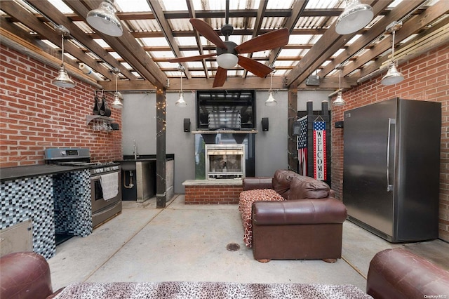 living room featuring ceiling fan and brick wall