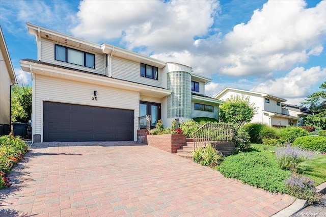 1233 Beech St Unit 35, Atlantic Beach, NY 11509 - view of front of home with an attached garage, decorative driveway, and french doors