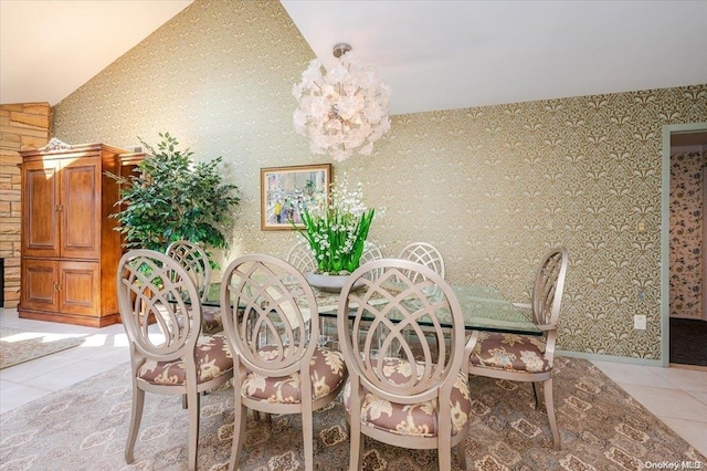 dining room featuring an inviting chandelier, vaulted ceiling, and light tile patterned flooring