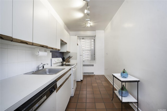 kitchen with sink, radiator heating unit, white appliances, decorative backsplash, and white cabinets