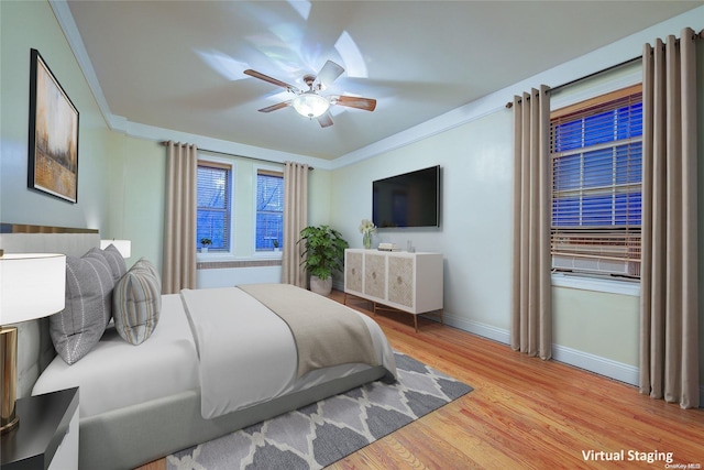 bedroom featuring light hardwood / wood-style flooring, ceiling fan, and ornamental molding