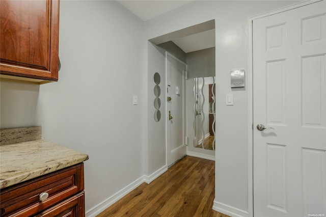 corridor with dark hardwood / wood-style floors