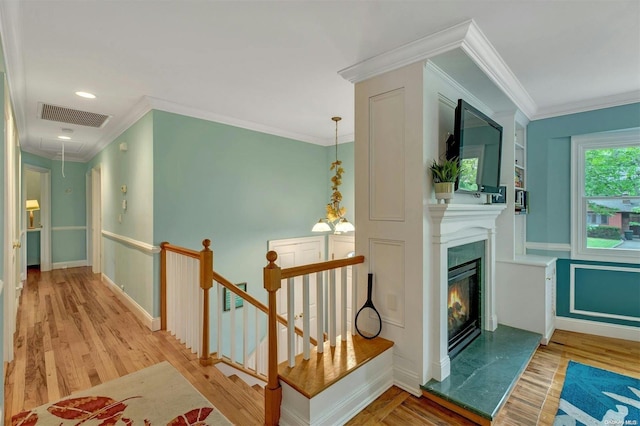 corridor with crown molding and light hardwood / wood-style flooring