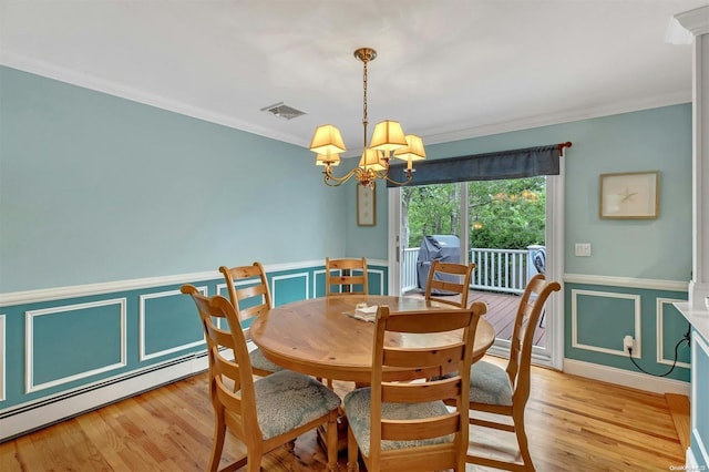 dining space with a notable chandelier, a baseboard heating unit, crown molding, and light hardwood / wood-style flooring