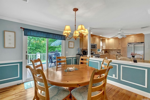 dining room with light hardwood / wood-style floors, ceiling fan with notable chandelier, and ornamental molding