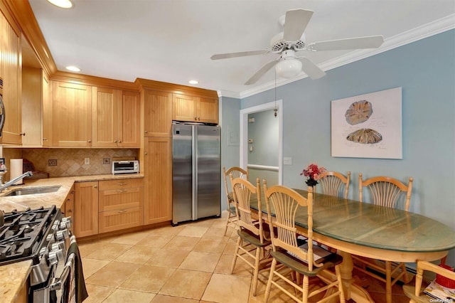 kitchen featuring backsplash, sink, ceiling fan, appliances with stainless steel finishes, and light tile patterned flooring