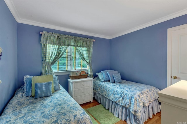 bedroom with wood-type flooring and ornamental molding