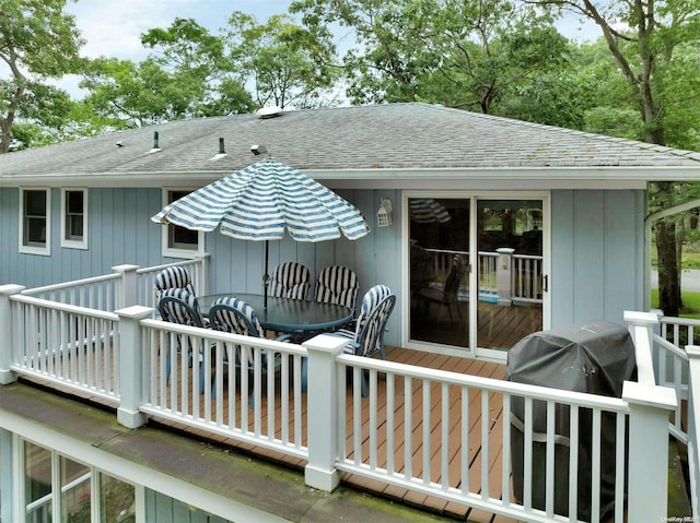 wooden terrace featuring a grill