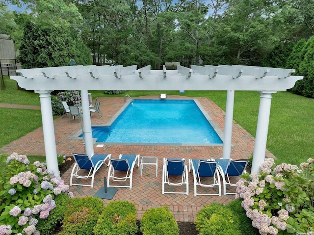 view of pool featuring a yard and a patio