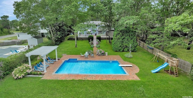 view of swimming pool featuring a yard, a pergola, a diving board, a playground, and a patio area