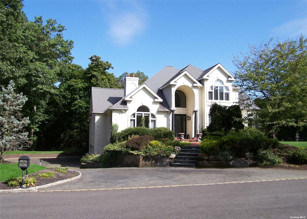 1 Kistela Ct, Northport, NY 11768 - view of front of house featuring a chimney and stucco siding