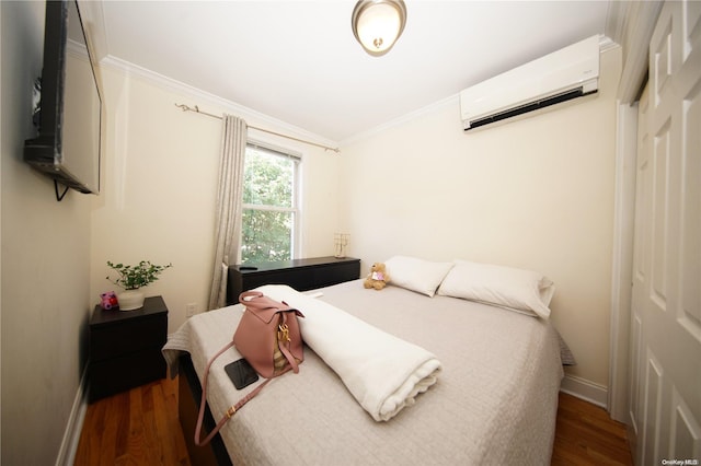 bedroom with crown molding, an AC wall unit, and dark wood-type flooring