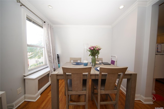 dining room featuring ornamental molding and hardwood / wood-style flooring