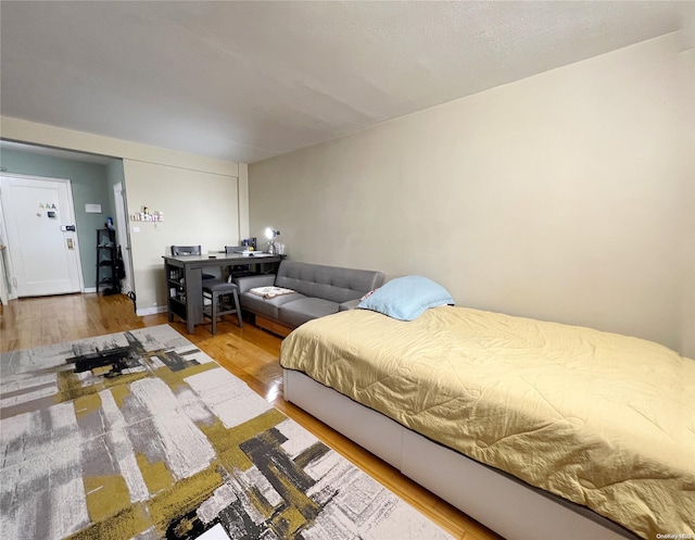 bedroom with hardwood / wood-style flooring