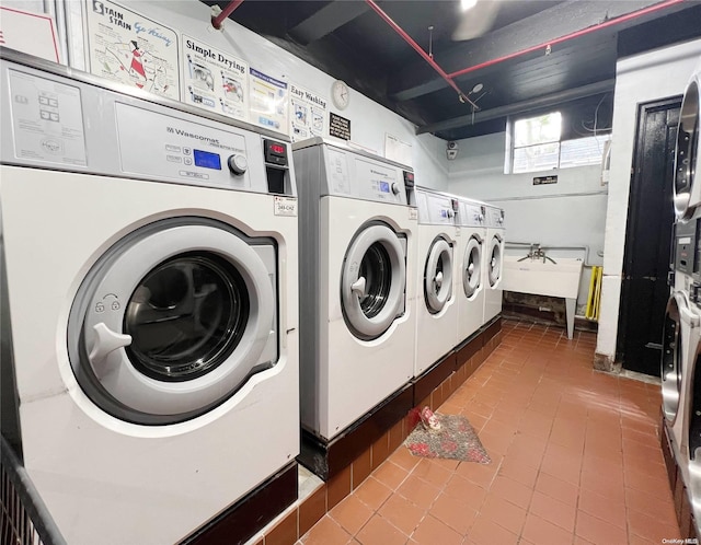 clothes washing area with separate washer and dryer