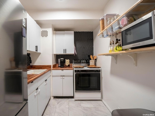 kitchen featuring decorative backsplash, sink, white cabinets, and stainless steel appliances