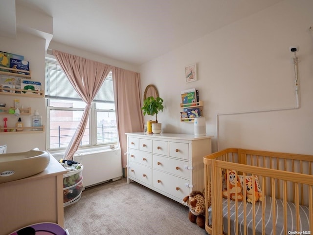 carpeted bedroom with a crib