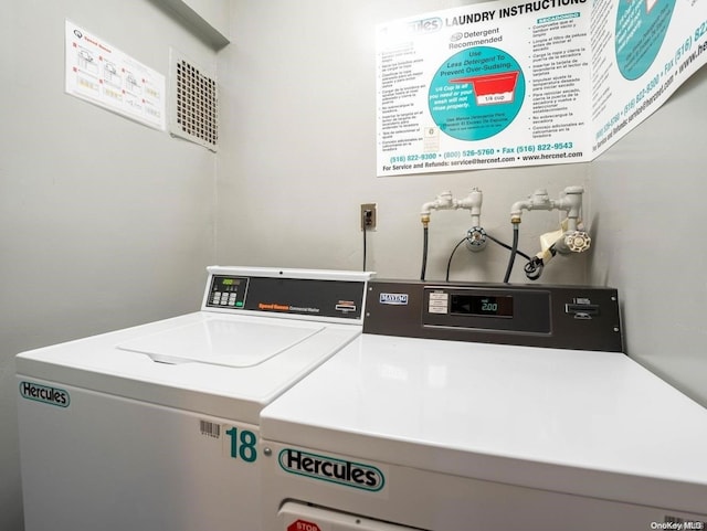 clothes washing area with washer and dryer