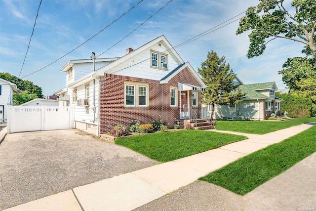 bungalow-style home with a front lawn