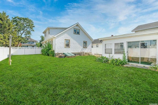 back of property featuring a lawn