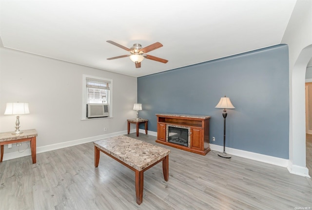 living room with light hardwood / wood-style floors and ceiling fan