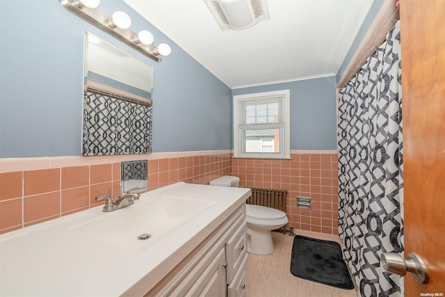 bathroom featuring vanity, tile patterned floors, crown molding, toilet, and tile walls