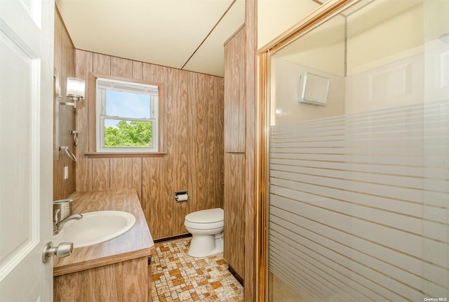 bathroom featuring vanity, an enclosed shower, and wooden walls