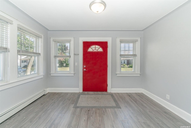 foyer featuring wood-type flooring and a baseboard radiator