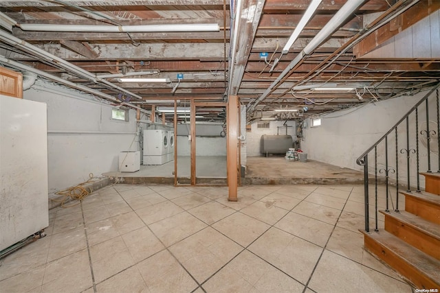 basement with white refrigerator and washer / clothes dryer