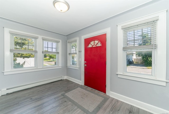 foyer featuring hardwood / wood-style floors and baseboard heating