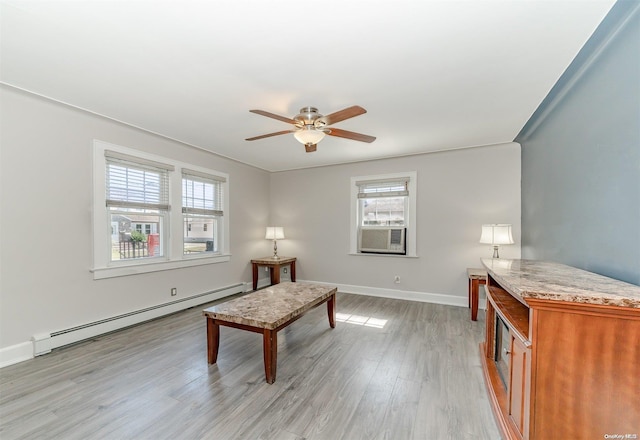 living area with cooling unit, light hardwood / wood-style floors, ceiling fan, and a baseboard heating unit