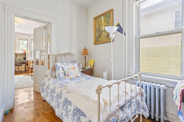 bedroom featuring radiator and parquet floors