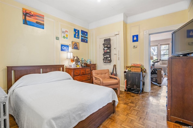 bedroom featuring parquet floors and ornamental molding