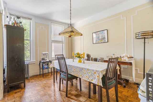 dining area with parquet flooring and radiator heating unit