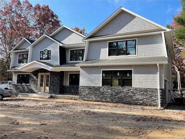 view of front of property featuring a porch and a garage