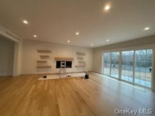 unfurnished living room with light hardwood / wood-style flooring