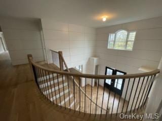 stairs featuring hardwood / wood-style flooring