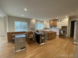 kitchen featuring a center island, white cabinets, and light hardwood / wood-style floors