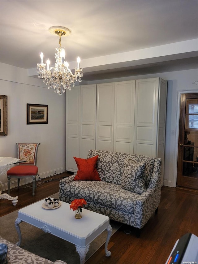 living room with a notable chandelier and dark hardwood / wood-style flooring