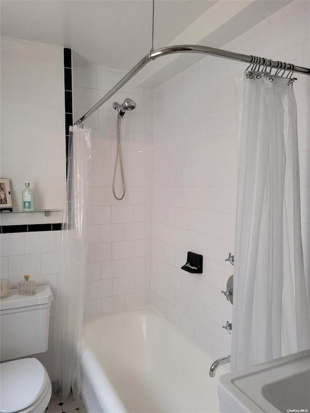 bathroom with shower / tub combo, toilet, and tile walls