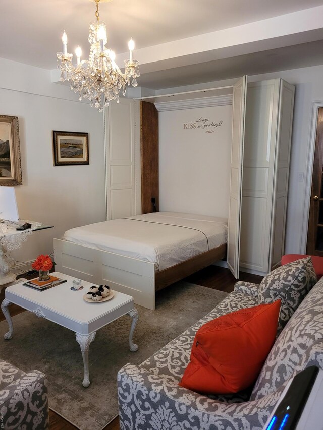 434 E 52nd St Unit 9A, New York Manhattan, NY 10022 - bedroom with a chandelier and dark wood-style flooring