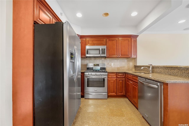 kitchen with sink, stainless steel appliances, light stone counters, decorative backsplash, and ornamental molding