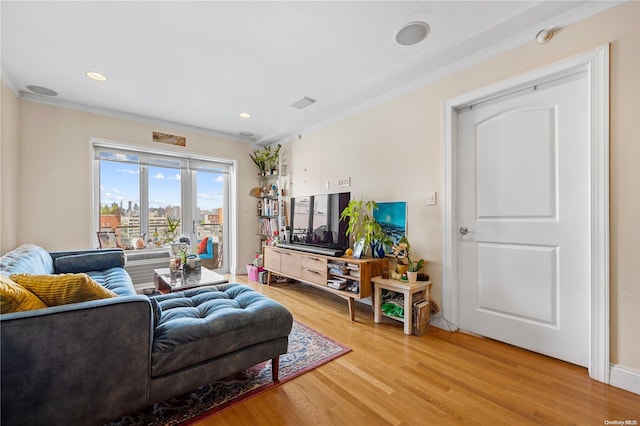 living room with hardwood / wood-style flooring and crown molding