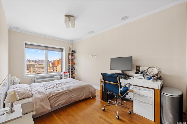 bedroom featuring light hardwood / wood-style flooring, a wall mounted AC, and ornamental molding