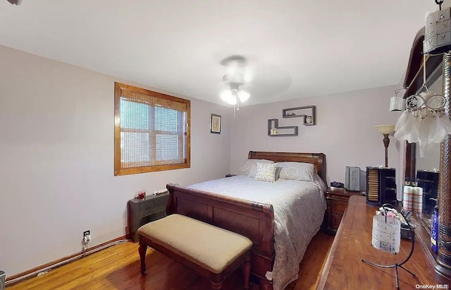 bedroom with hardwood / wood-style flooring and ceiling fan